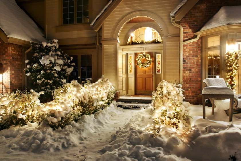 Image of house with bright white christmas lights and holiday decorations