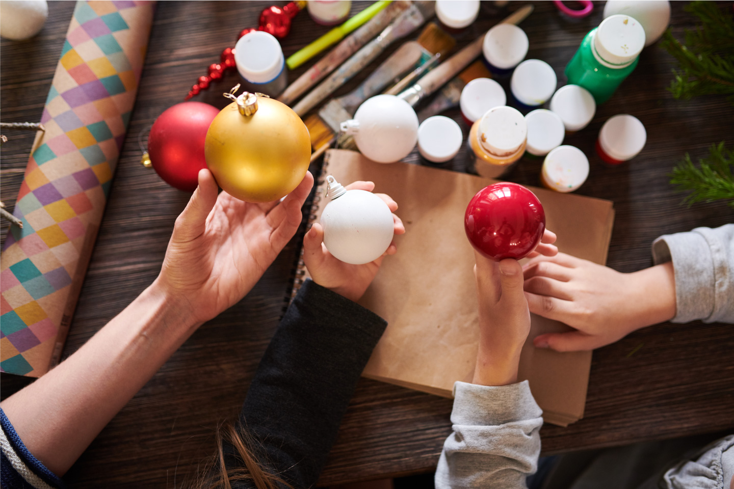 An image of people decorating christmas ornaments